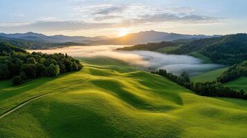 Breathtaking sunrise over rolling green hills with misty valleys photo