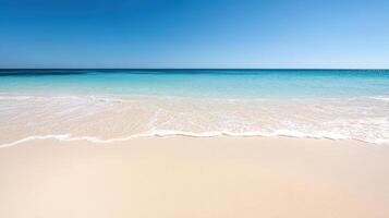 tranquil beach with gentle waves and soft sand under clear sky photo