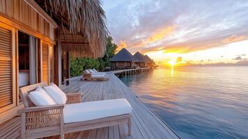 serene sunset view of overwater bungalows by calm sea photo