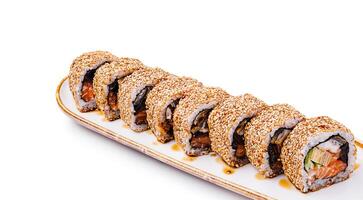 Delicious sushi rolls arranged on a white plate with sesame seeds photo