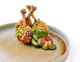 Crispy chicken drumsticks with fresh cucumber salad photo