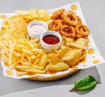 Tasty platter of appetizers with dips and crunchy snacks photo