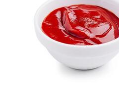 Freshly served ketchup in a white bowl on a clean background photo