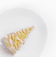 Lemon drizzle cake slice on white plate closeup photo