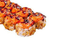 Spicy sushi rolls topped with tobiko and unagi sauce laying on white photo