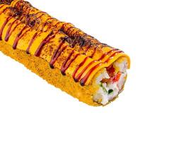 Sushi roll is lying on a white surface, covered in sauce and sesame seeds closeup photo