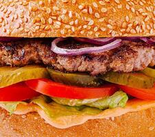 Savory hamburger loaded with fresh toppings and sesame bun photo