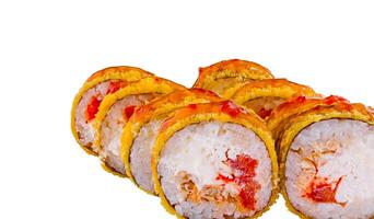 Tempura sushi rolls covered with spicy sauce and sesame seeds on white background photo