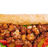 Crispy cauliflower and fresh veggies in a vegan sandwich photo