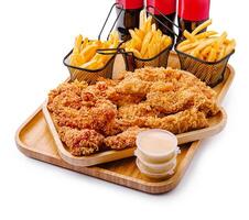 Delicious fried chicken with crispy fries and refreshing drinks photo