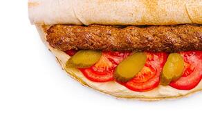 Delicious wrap filled with grilled meat and fresh vegetables photo