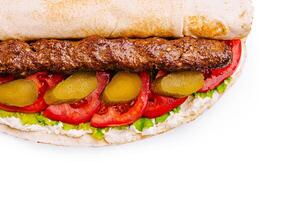 Freshly made sandwich with grilled meat and vegetables photo