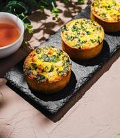 Savory spinach and cheese muffins on a serving platter photo