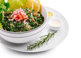 Fresh tabbouleh salad with herbs and vegetables on a plate photo