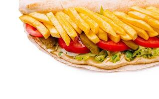 Delicious wrap filled with fresh vegetables and crispy fries photo