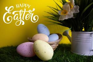 Pastel colorful Easter eggs with Daffodil flowers in background Happy Easter photo