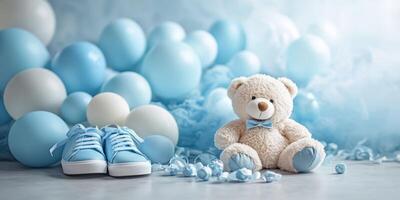 Decorative baby shower setup with blue balloons, shoes, and teddy bear in a soft ambiance photo