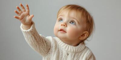 Baby reaching out toward the sky with a curious expression in a warm sweater during a cozy indoor moment photo