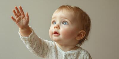 Baby reaching out with curiosity in a softly lit indoor space during the morning hours photo