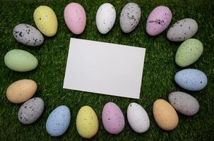 Card for message with Easter frame of colorful eggs on grass photo