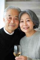 An older couple holding a glass of wine photo