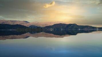 Fjord with view of mountains and fjord landscape in Norway. Blue sky, white clouds. photo