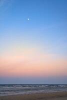 Moon in the sky in front of the beach on the island of Usedom on the Baltic Sea. photo