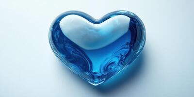Heart-shaped glass object filled with blue liquid reflects light beautifully on a white surface photo
