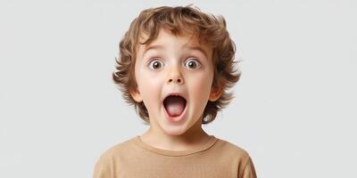 Child expresses surprise with wide eyes and open mouth, capturing a moment of pure joy indoors photo