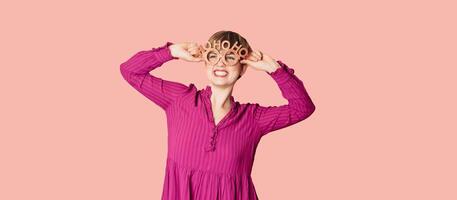 A beautiful young woman with festive New Year's joy, wearing Christmas glasses on a bright background with a place for text photo