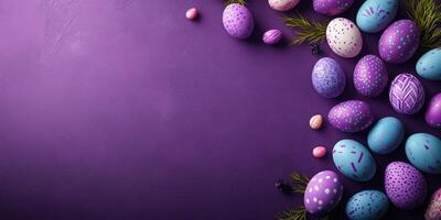Colorful decorated Easter eggs arranged on a purple background with greenery, perfect for festive celebrations and spring gatherings photo