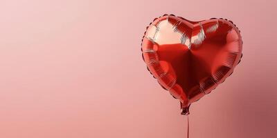 Heart-shaped red balloon floating against a soft pink background creating a romantic and cheerful atmosphere photo