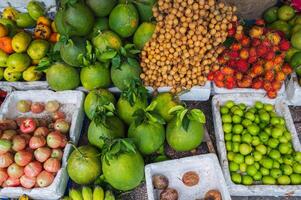 A counter with tropical fresh fruits at an Asian local market. photo