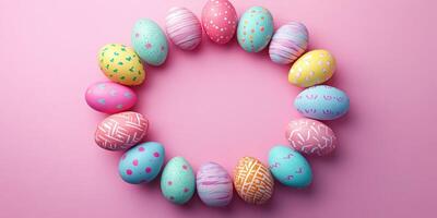 Colorful Easter eggs arranged in a circle on a pink background for spring celebration photo