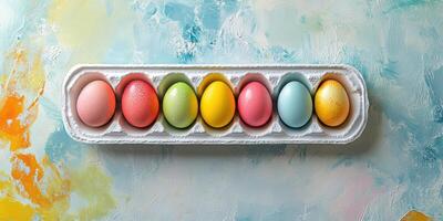 Colorful decorated eggs arranged on a carton against a vibrant artistic background during spring celebration preparations photo