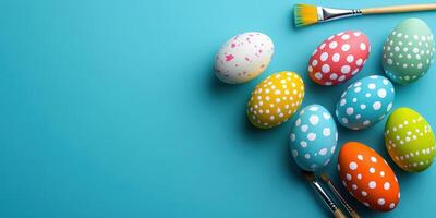 Colorful decorated eggs with brushes on a blue background during a spring crafting session photo