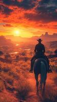 Cowboy riding into sunset across canyon landscape with vibrant clouds and warm colors in the evening photo