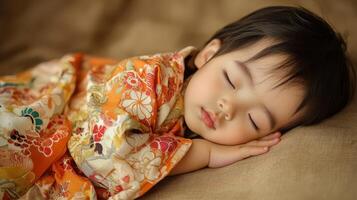 Child sleeping peacefully in vibrant traditional clothing on soft fabric in a serene indoor setting photo