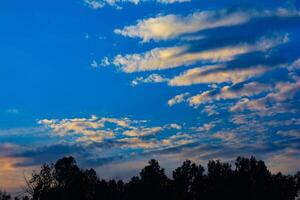 Beautiful sunset and sunrise over the mountains with colorful skies and silhouettes of trees photo