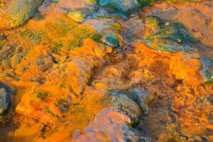 Abstract colorful red and yellow texture with rust, metal, and stone patterns, evoking a vintage, rusty, and natural surface photo