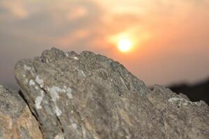 the sun down on the peak of mountain photo