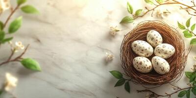 Decorative easter eggs in a natural nest surrounded by greenery on a marble surface photo