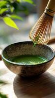 serene moment of matcha green tea preparation, showcasing bamboo whisk blending vibrant green tea in textured bowl photo