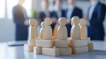 Wooden figures representing teamwork and collaboration in business setting photo