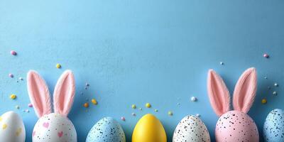 Colorful Easter eggs with bunny ears and decorations on a blue background in a festive display photo
