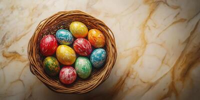 Colorful Easter eggs arranged in a wicker basket on a marble surface during the spring season photo