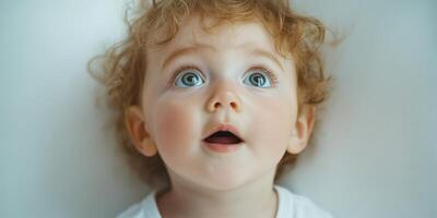 Child with curly hair gazing up in wonder, capturing innocence and curiosity in a bright indoor setting photo