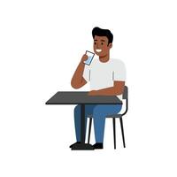 A man sitting at a table with a cell phone vector