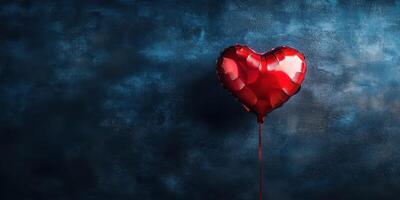 Red heart balloon floats against a textured blue backdrop, perfect for romantic celebrations or artistic displays photo