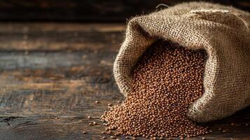 Sack of grains spilling onto wooden surface, showcasing natural textures and colors photo